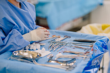 Valmiera, Latvia - March 20, 2024 - a surgeon's hands are shown with surgical instruments on a...