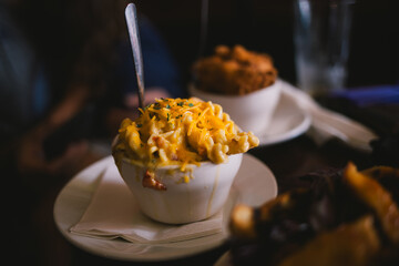 Close-up of melted cheesy pasta in a bowl at a restaurant