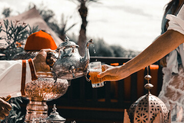 Traditional Moroccan mint tea served in a restaurant in Marrakesh - obrazy, fototapety, plakaty