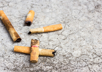 Cigarette butt discarded on the cement floor