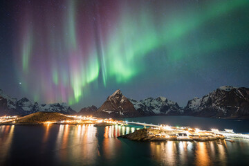 A lot of  beautiful color of northern light  in the sky on top view  of Reine city , Lofoten ,Norway