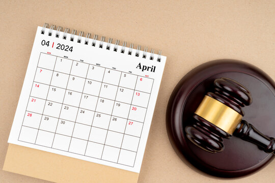 Desk calendar for April 2024 and judge's gavel.