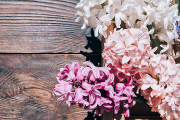 Hyacinths on a wooden background. Bouquet of flowers on a brown table.