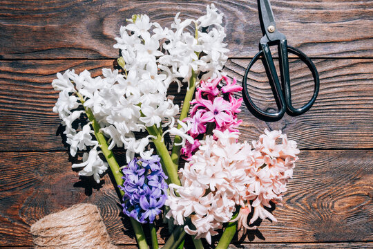 Hyacinths on a wooden background. Bouquet of flowers on a brown table.