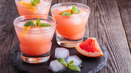 Grapefruit cocktail with ice and mint.