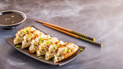 gyoza or dumplings snack with soy sauce - 765435782