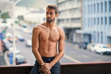 Man, sexy and shirtless with muscle on balcony with confidence or pride, relax and thinking on...