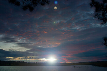 Sunlight and its lens flare is shinning through sunrise twilight cloud