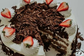 A Black Forest Cake with Strawberries Topping