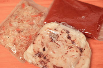 ake-away pupusas wrapped in paper and plastic, served with curtido and sauce, ready to enjoy anywhere.
