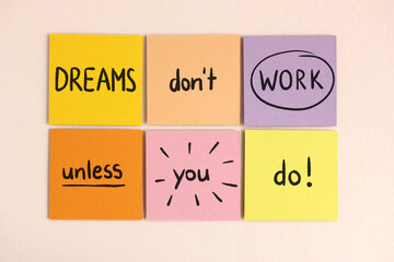 Dreams don't work unless you do - Motivational career quote hand-written on colorful sticky notes
