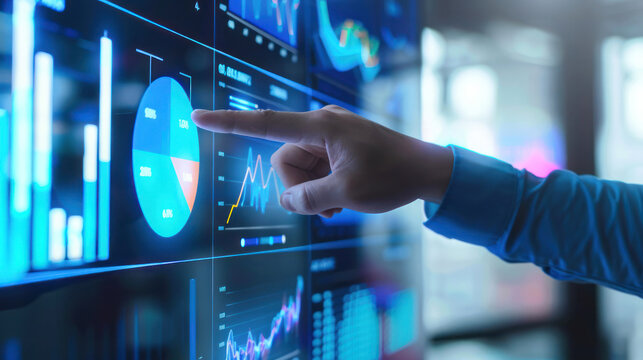 Hand pointing at a pie chart on a high-tech digital screen with various data analytics displayed