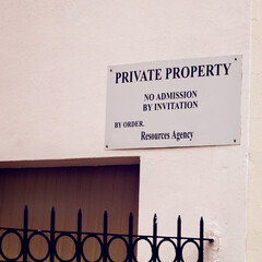 Warning, private property and sign for trespassing on wall for mistake, information or comic...