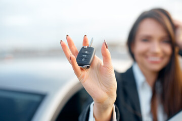 young business woman holding car keys. Concept of buying car.