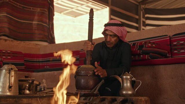 A Bedouin Man Grinding Coffee