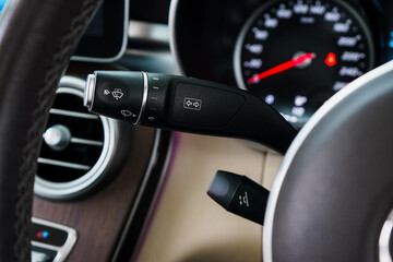 Switch off lights in a car. close-up Car integrated turning indicator with headlight switch toggle.	