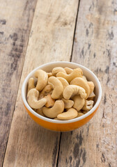 Cashew nuts in the bowl on wooden table