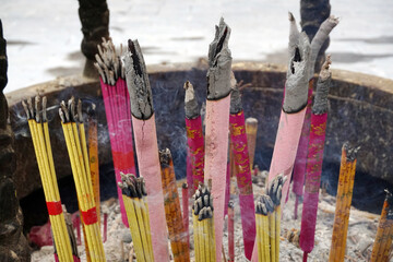 Votive incense sticks burn in a temple incense burner in China