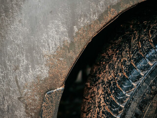 Car fender and tire covered in mud. Living in rural area with bad road and far from comfort of a...