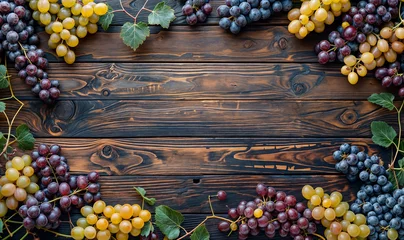 Deurstickers red and white/ yellow grapes seen from above on a wooden table top wallpaper with copy space © Deea Journey 