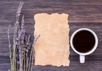 Old paper and coffee on dark wooden table background.