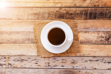 Cup of coffee on old wooden table background