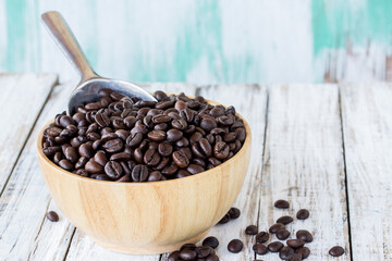 Big stainless steel scoop of coffee beans