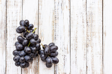 Grapes on white wooden table background