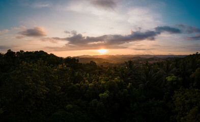 Capturing the Breathtaking Sunset Over Lush Jungles of Indonesia's Lombok Island: A Spectacular Aerial View Captured by Drone
