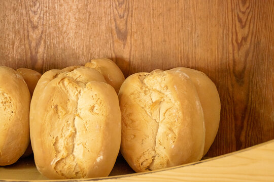 Panes de pueblo al estilo tradicional español. Pan de trigo de 1 kg de masa expuesto en un estante para la venta. Panadería en Sanlúcar de Guadiana, Andalucía, España.