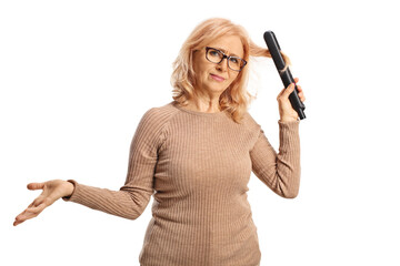 Confused woman using a hair straightener