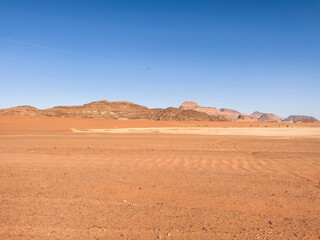 Fototapeta na wymiar Wadi Rum Desert In Jordan. Yellow and Orange Desert Sand under the Blue Sky