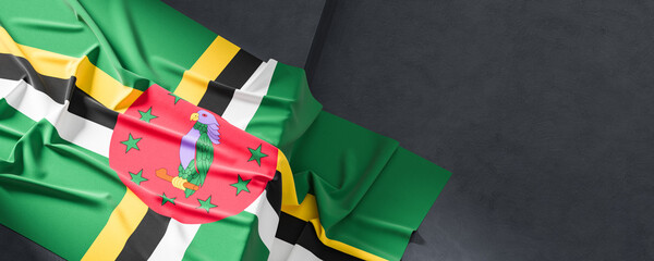 Flag of Dominica. Fabric textured Dominica flag isolated on dark background. 3D illustration - 765525557