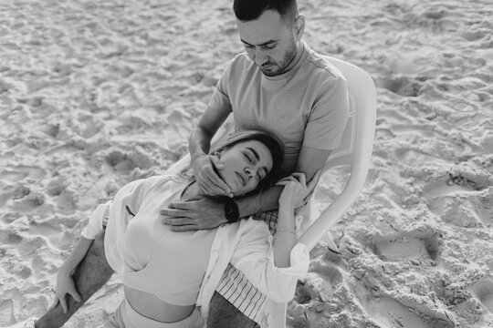 Couple on the beach of Mediterranean Sea, golden hour, sunset, blue sky, lifestyle