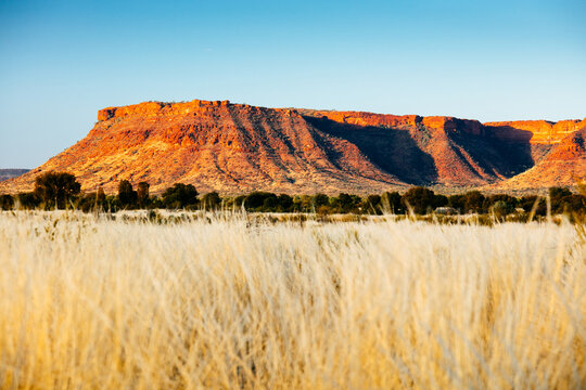 Sunset colours on the rising landforms above the plains near Kings Canyon in Central Australia
