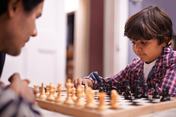 Child, father and chess strategy or planning checkmate move with knight, king or queen. Son, parent...