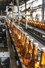 A factory dedicated to the production of beer and cider showcasing a bottling plant manufacturing bottles in a factory setting