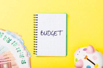 Budget headline in notebook on yellow background