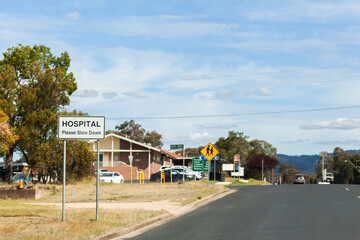 Hospital please slow down sign in small country town before hospital building