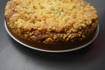 Kitchen, delicious homemade pie with pumpkin and apricot pieces placed on a white plate.