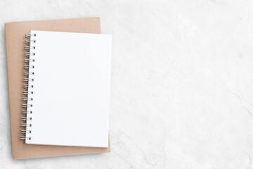 Blank notebook or notepad on white office desk background.