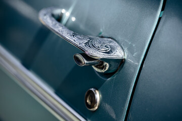 The door handle of a retro car, close-up.
