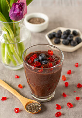 Chocolate oatmeal and chia seeds smoothie glass with blueberries