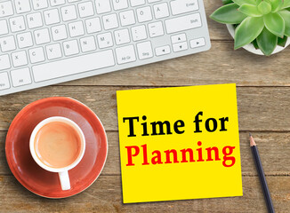 Text Time for Planning on yellow card and laptop keyboard with mug of beverage
