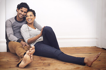 Couple, floor and touch for care and love in home, smile and proud of marriage and commitment....