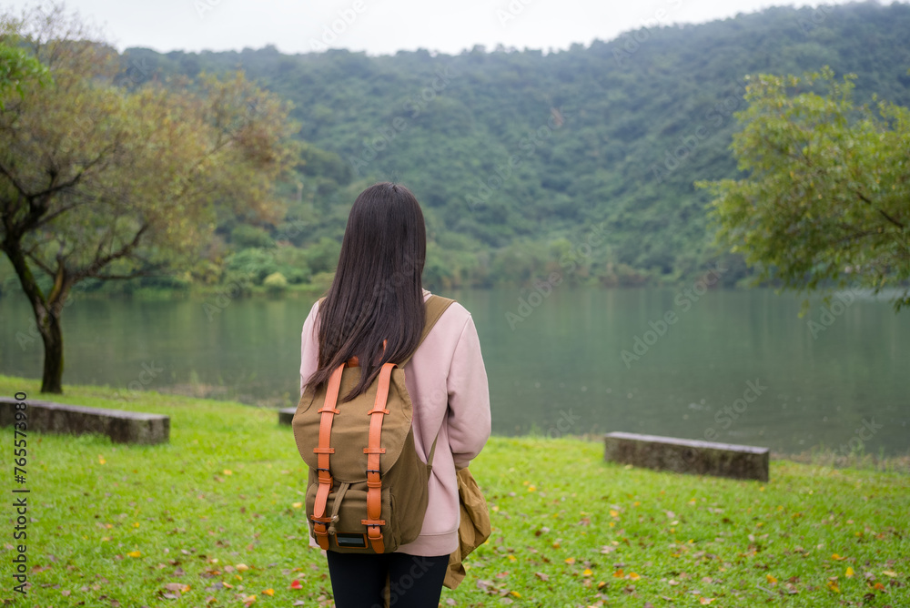 Poster woman enjoy the lake view in the countryside