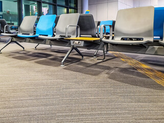 Istanbul, Turkey - October 30, 2019: Row of chairs in the waiting room of Istanbul Airport. Bottom view of carpeted floor and empty plastic seats in a modern international terminal