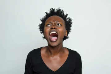 Fotobehang black woman is yelling on solid white background © Igor