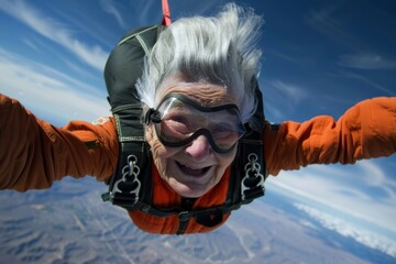 Funny and smiling elderly woman has fun skydiving - obrazy, fototapety, plakaty