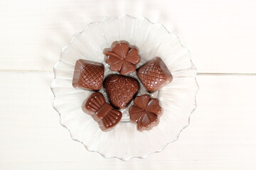 Chocolate Pralines on glass plate. DIrectly Above.